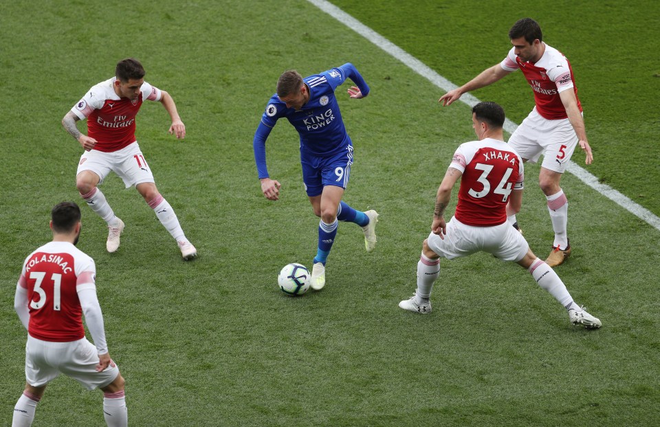 Jamie Vardy gets away from four Arsenal players during their 3-0 defeat at Leicester