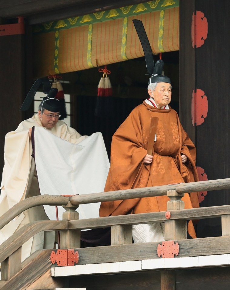 Emperor Akihito is shown in traditional costume, reporting his voluntary abdication to a Shinto sun goddess