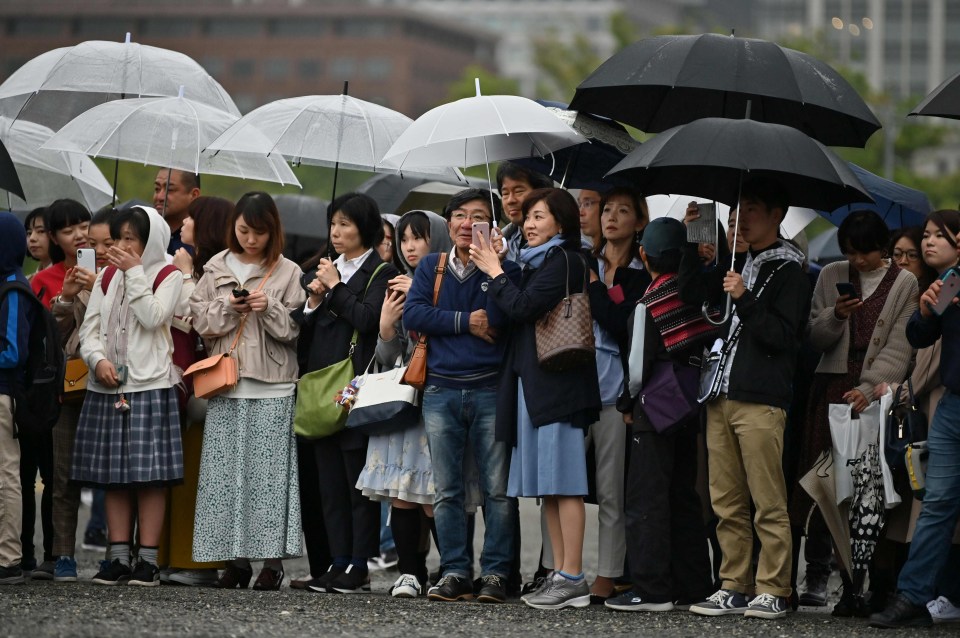 Well-wishers line streets to catch a glimpse of the ‘People’s Emperor’