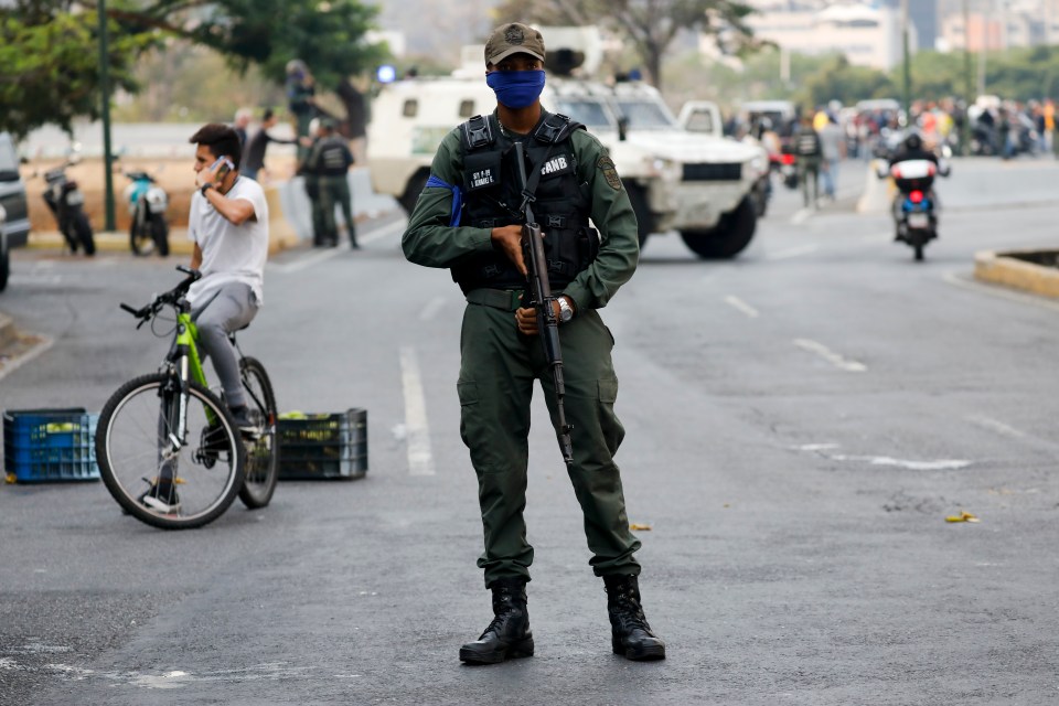  A soldier stands on an avenue leading up to the military base