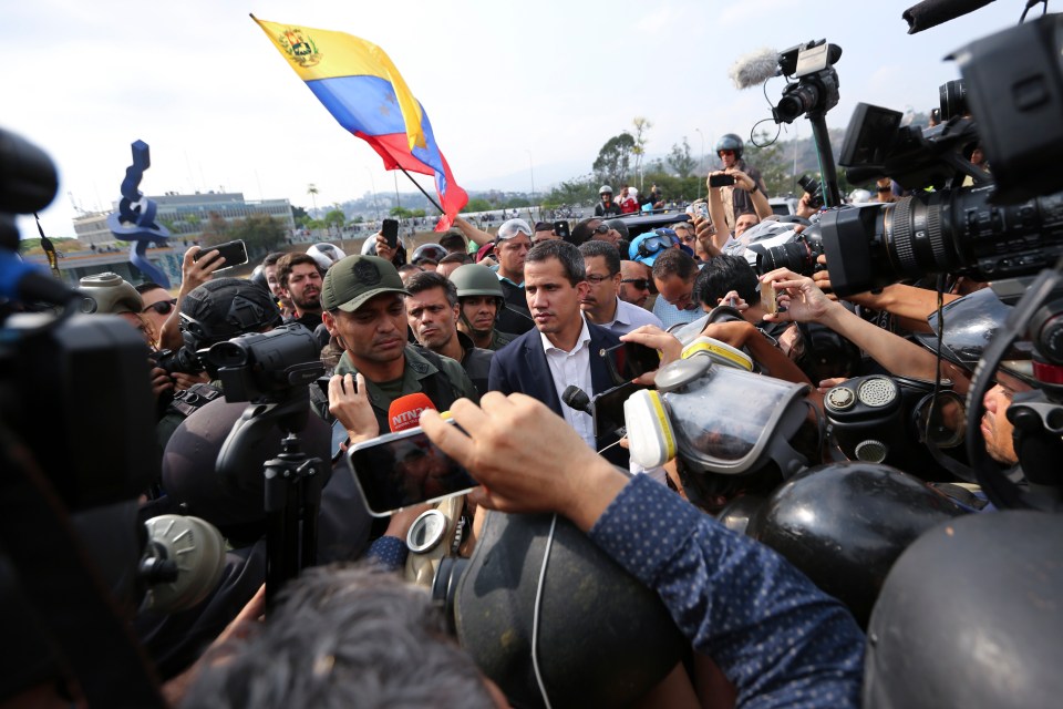  Guaido talking to a military officer outside La Carlota air base