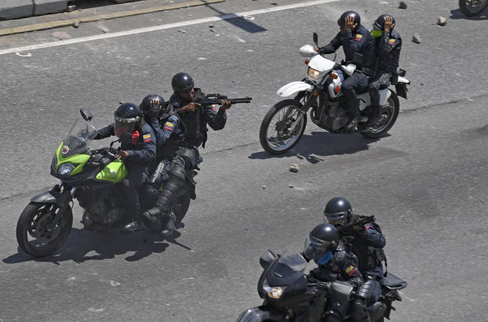  National Bolivarian Police officers open fire against opposition demonstrators during clashes