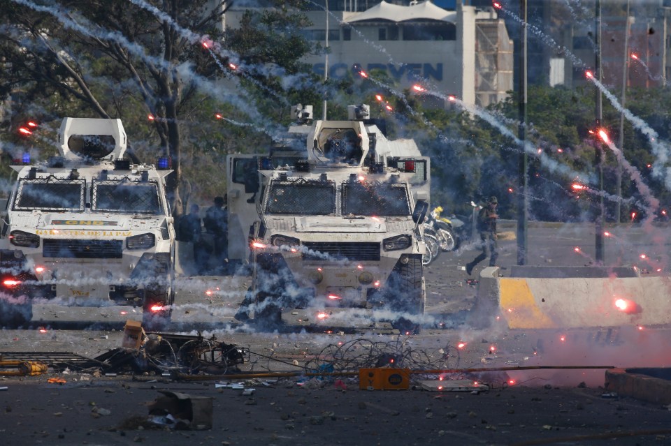  Fire crackers launched by demonstrators land near military vehicles