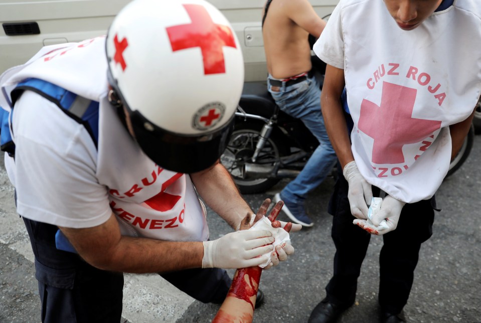  A wounded opposition demonstrator receives medical attention