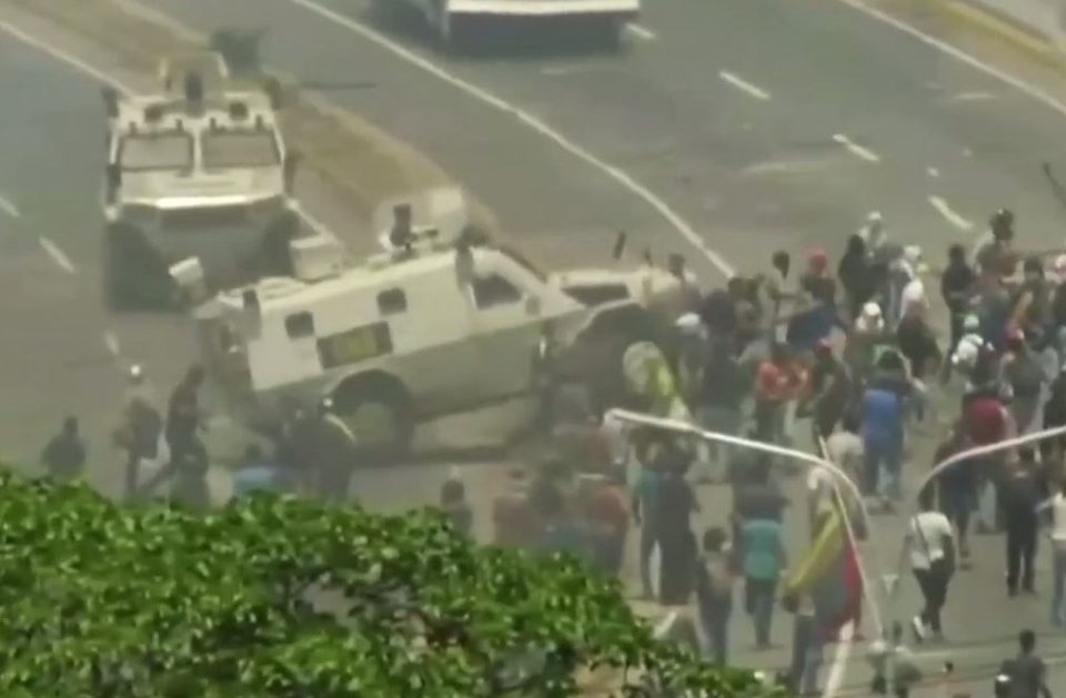  An armoured car drives into a crowd of protesters as violence spills out onto the street in Caracas, Venezuela