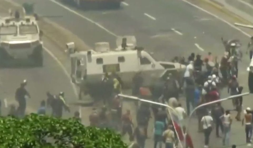  Under orders? The armed personnel carrier appears to deliberately drive into crowds