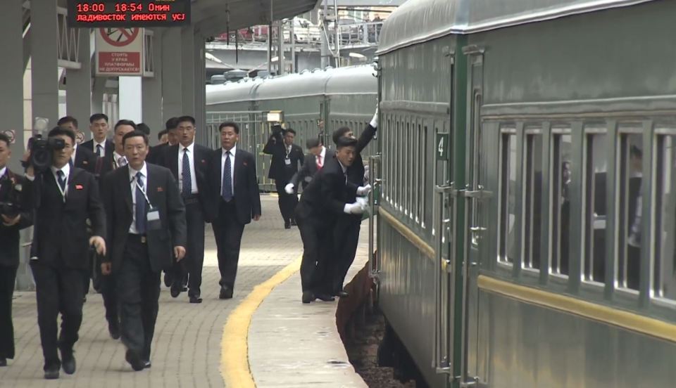  Kim Jong-un's jogging bodyguards are seen polishing his train carriage before it has even stopped moving