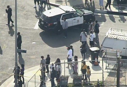  Crowds outside the police cordon in LA after the rapper and two other men were shot