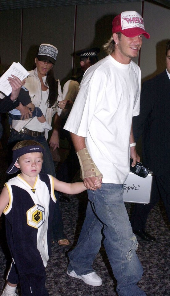 David Beckham pictured with his son Brooklyn and baby Romeo at Heathrow Airport in 2003