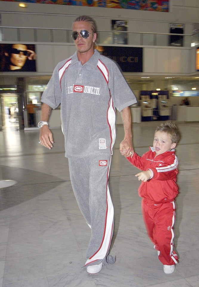 David pictured holding son Brooklyn’s hand at Nice terminal in 2003