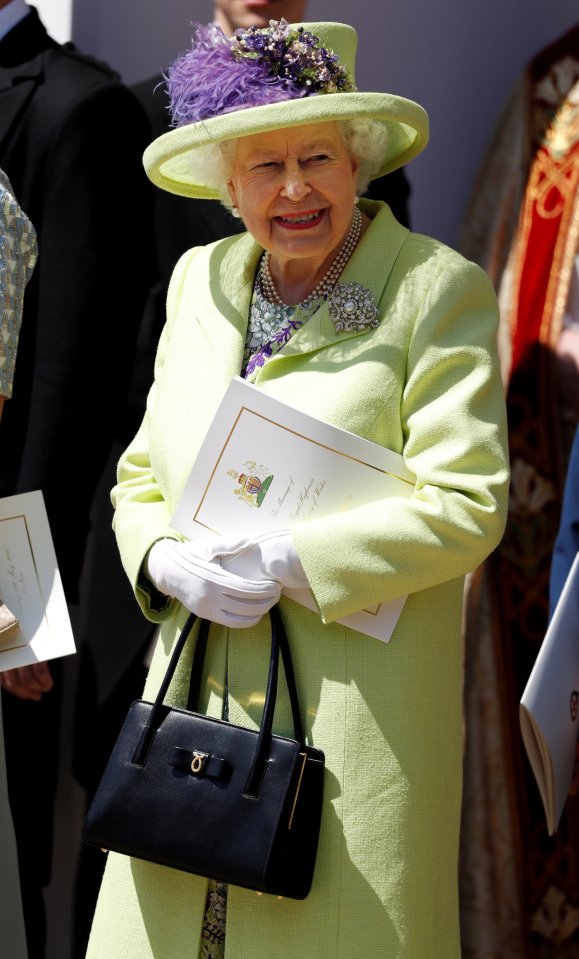  The Queen first wore this lime green coat, floral dress and black leather handbag to Prince Harry and Meghan Markle's wedding last year