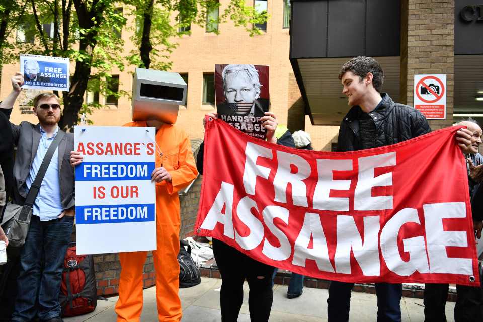  Protesters gather outside the Ecuadorian embassy in London as Julian Assange's belongings are confiscated