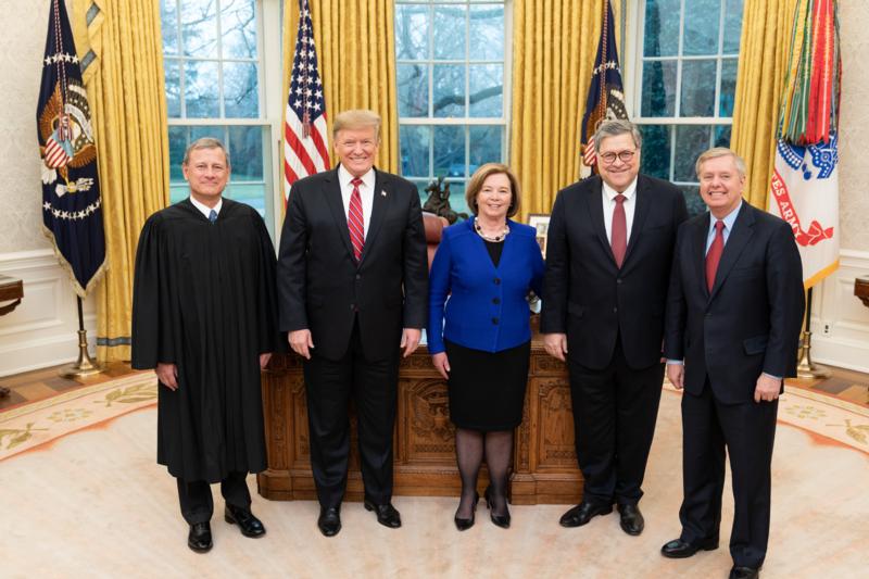  Trump standing with Barr in the White House's Oval Office