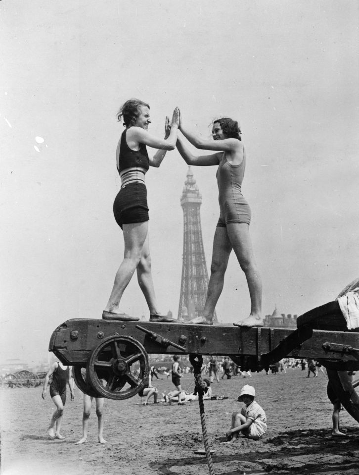  10th July 1934: Two holidaymakers enjoying the heatwave on the beach at Blackpool