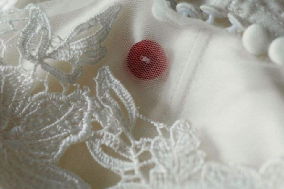 Katrice’s red button was sewn into Natasha’s wedding dress