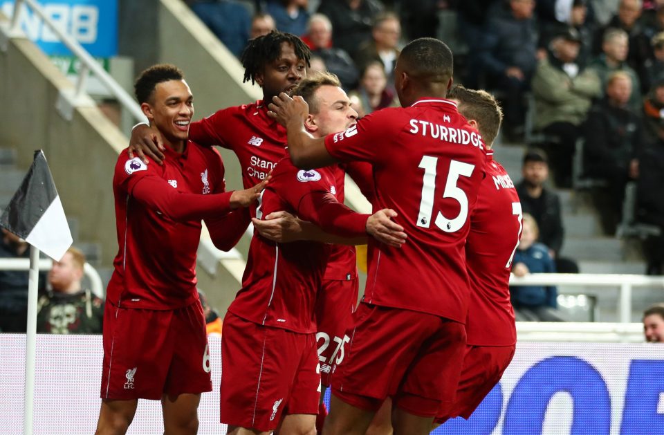  Reds players mob Origi and Xherdan Shaqiri after the late winner