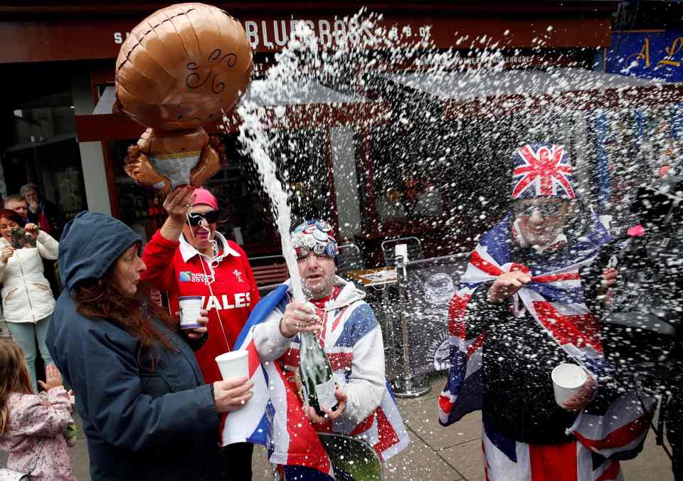  Royal super fan John Loughery pops the cork on a bottle of champagne near Windsor Castle