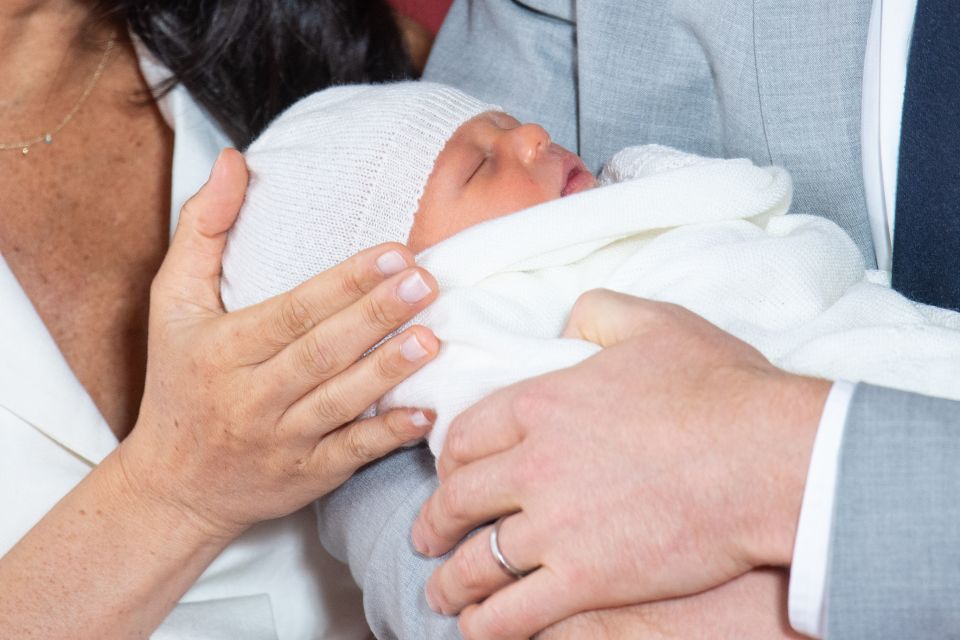  The baby looked happy snoozing in his proud daddy's arms