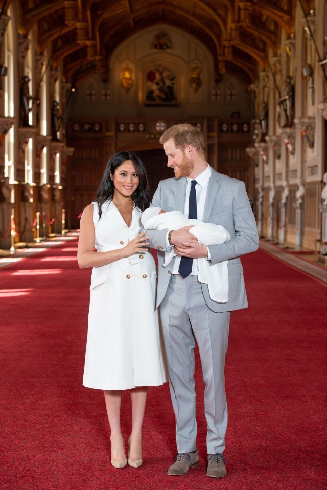  Prince Harry looks lovingly at Meghan - having praised her after the Monday birth