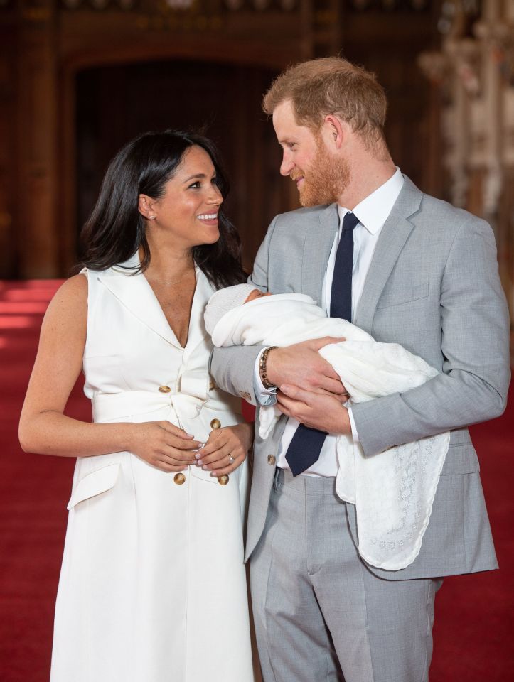  The happy parents looked adoringly at each other as they cradled their two-day old son