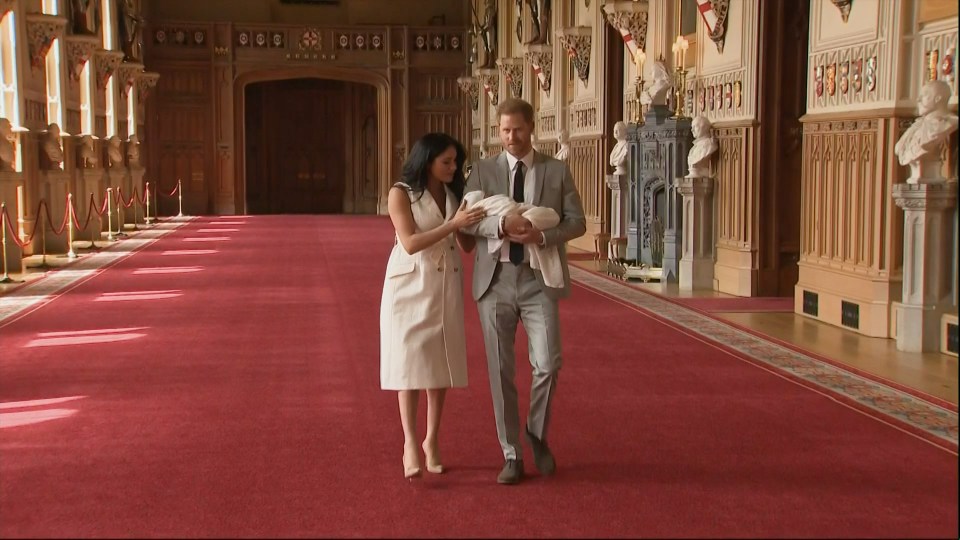  Meghan put her hand on her 'two boys' as royal watchers were left delighted to catch a glimpse of the couple's son