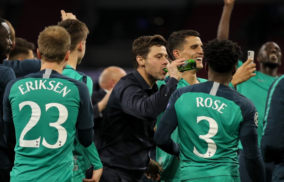  Mauricio Pochettino swigs beer in celebration after Spurs' win over Ajax