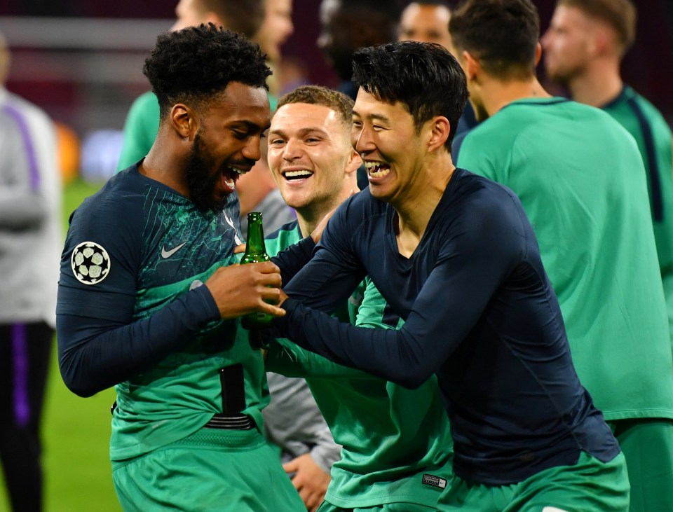  Danny Rose holds a bottle of beer while he celebrates with Heung-min Son