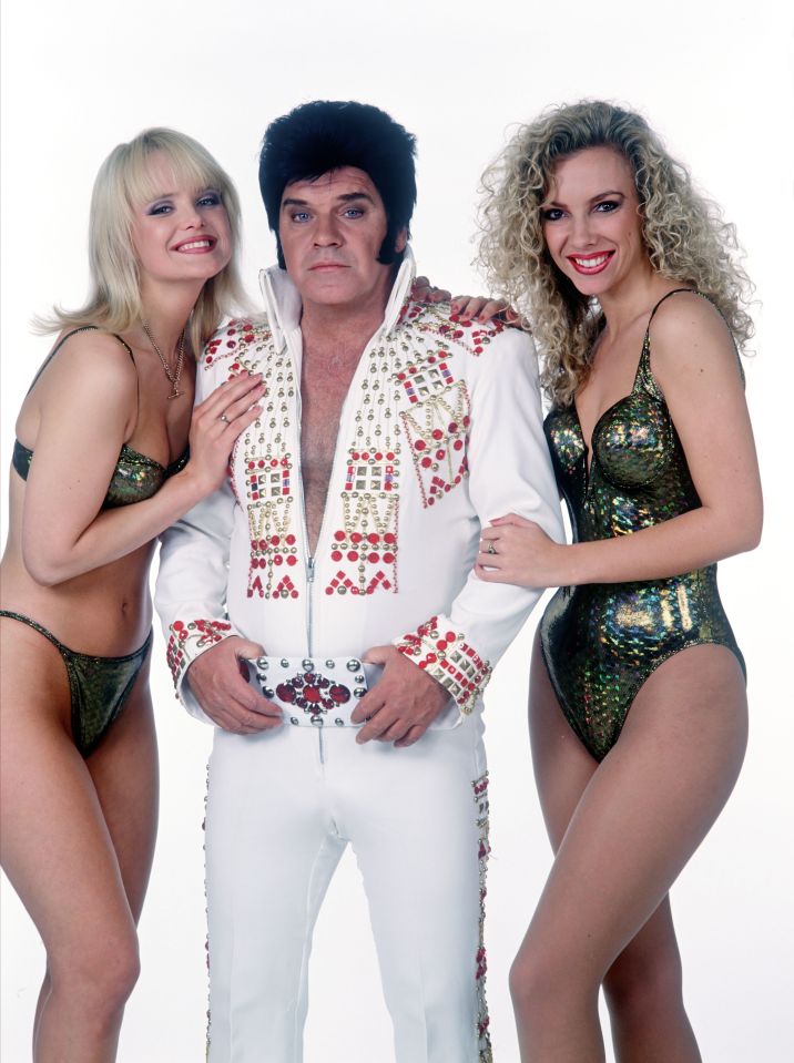  The star poses in an Elvis costume with some glamour girls