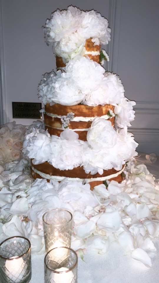  Their wedding cake was covered in white flowers