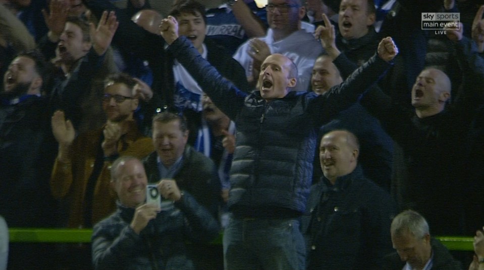  Mike Dean gave it his all in the terrace as he cheered Tranmere on to victory