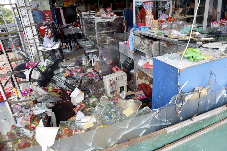  The wreckage of a shop that was attacked by a mob in Minuwangda