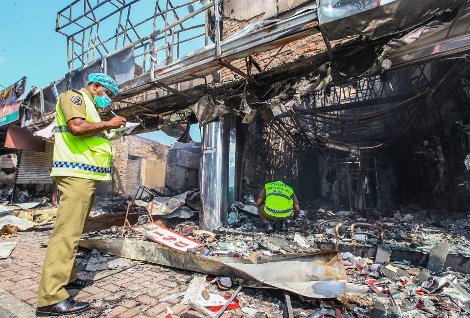  Crime scene officers inspect damaged Muslim-owned shops