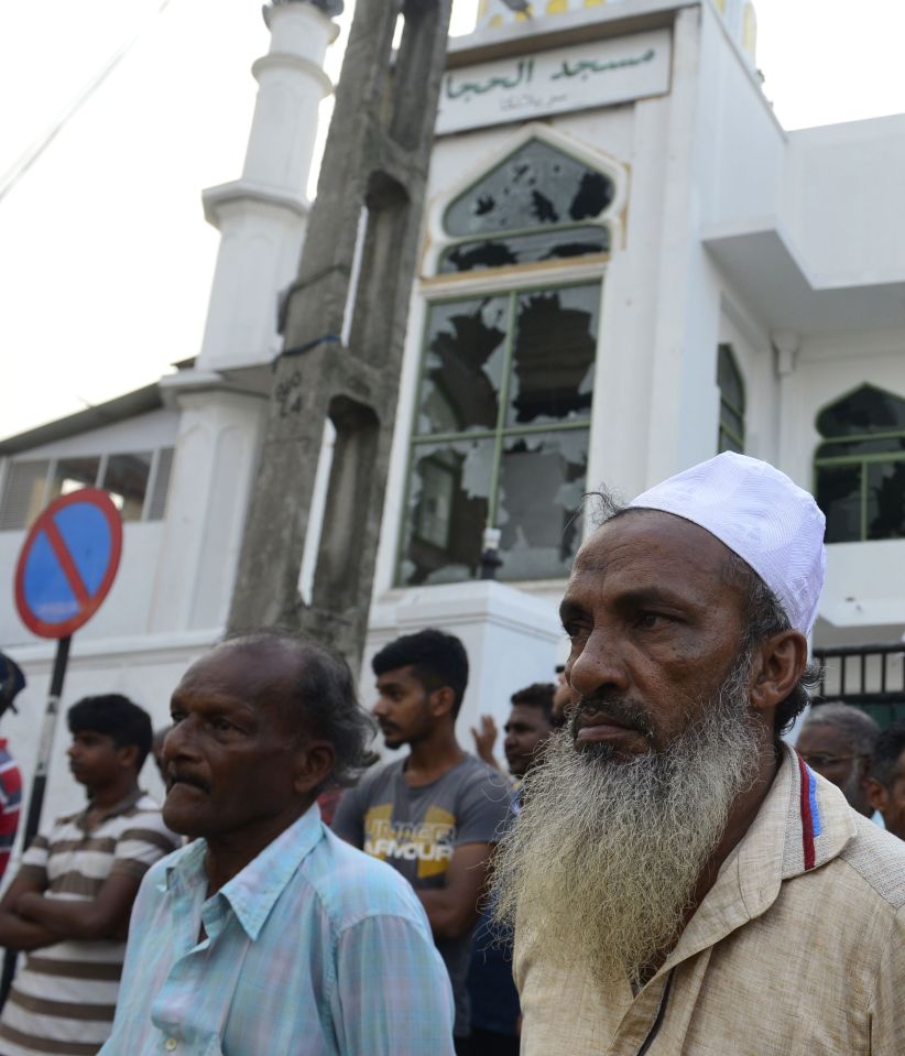  Men standing outside the Jumha Mosque after it was attacked