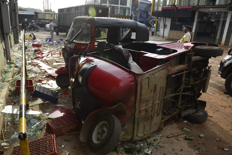  A rickshaw vehicle is pictured on its side after a mob attack in Minuwangoda