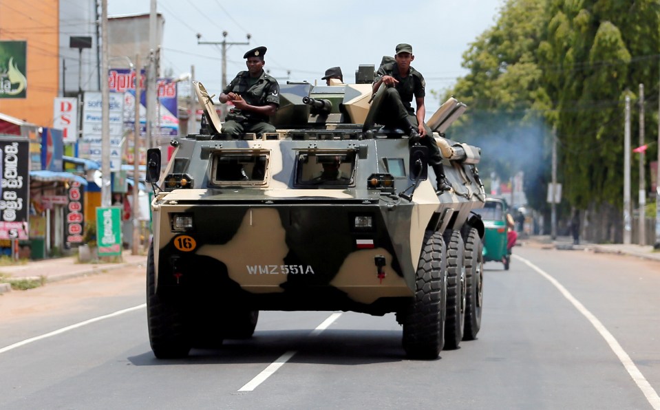  Sri Lankan soldiers patrol a road after a mob attack in a mosque in Hettipola, Sri Lanka