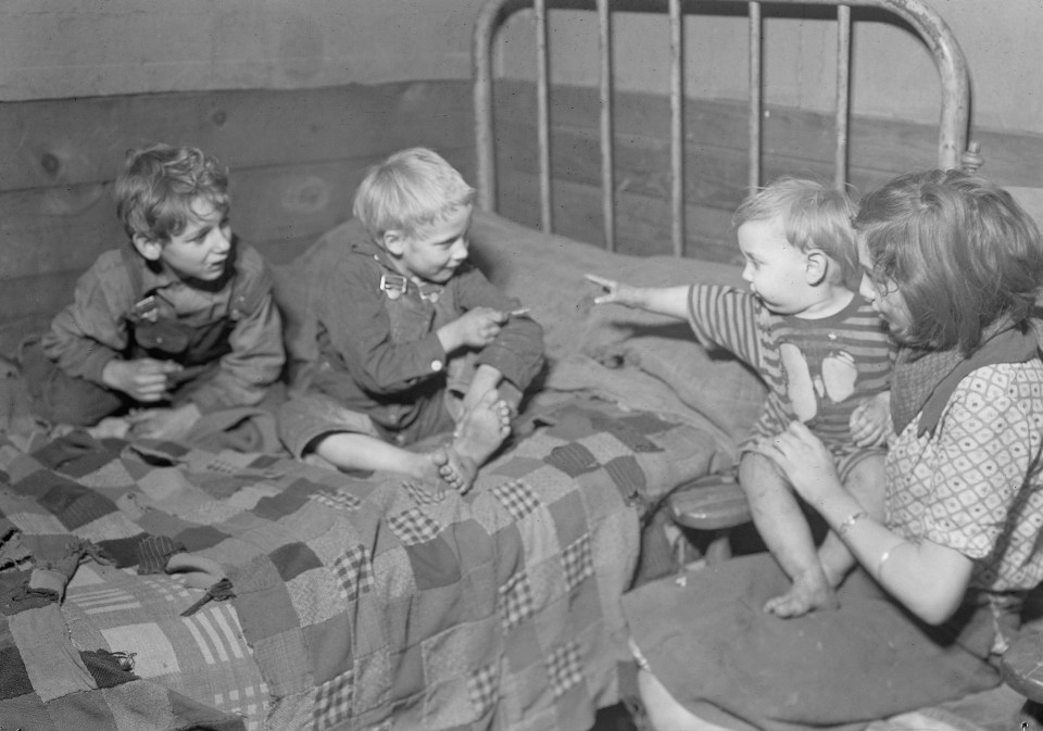 This photo was taken in 1936, seven years after the Wall Street Crash. It seemly likely that all three children have known nothing but poverty