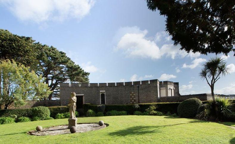 Statues sit among the green lawns in the vast garden