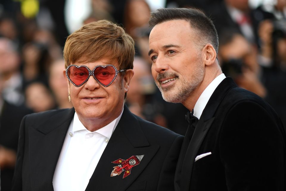  David beamed as he walked Elton along the star-studded carpet