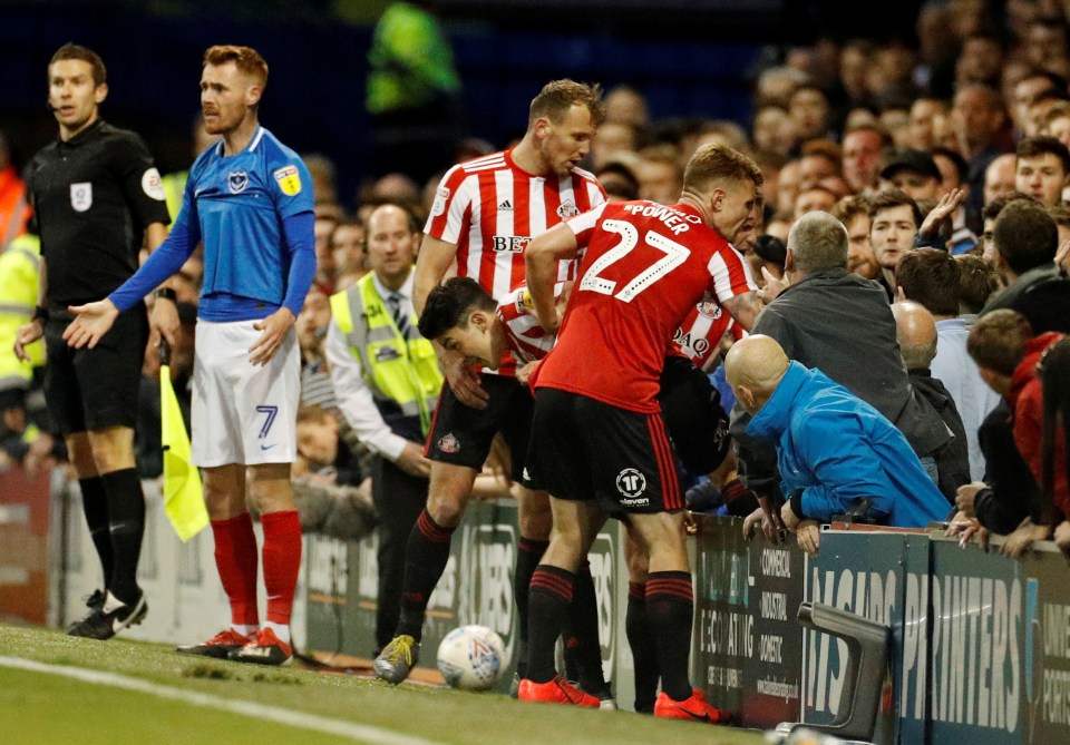  O'Nien climbs out the crowd as Sunderland team-mates remonstrate with the Pompey fans