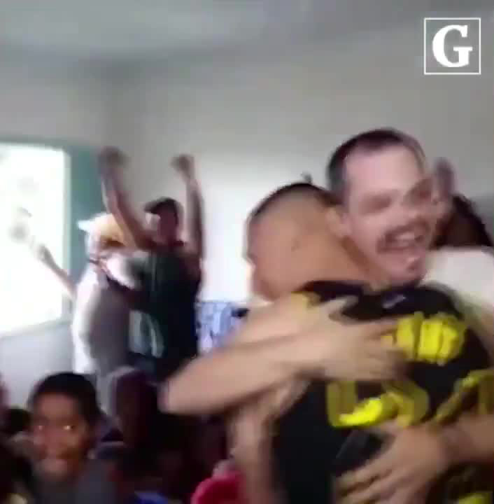  The 22-year-old is hugged by one of his family members as others cheer and clap in the background