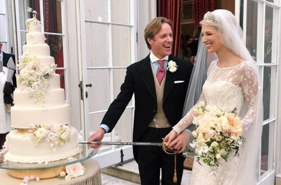  The couple cut the cake with a sword