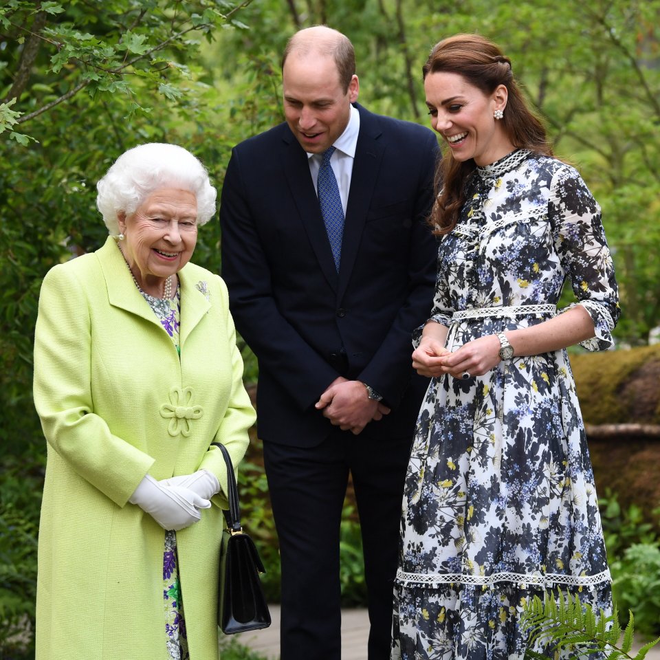  Kate and Prince William laugh as they show the Duchess' design to the Queen