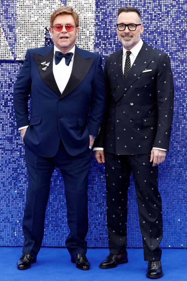  Elton John and David Furnish pose on the red carpet at the UK premiere of Rocketman