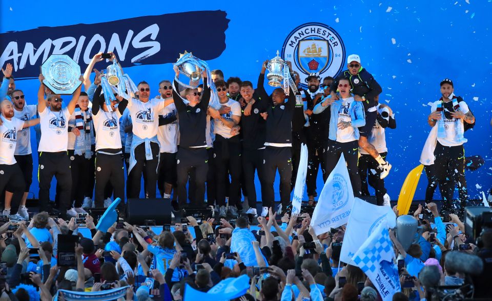  Manchester City paraded their three trophies through town on Monday