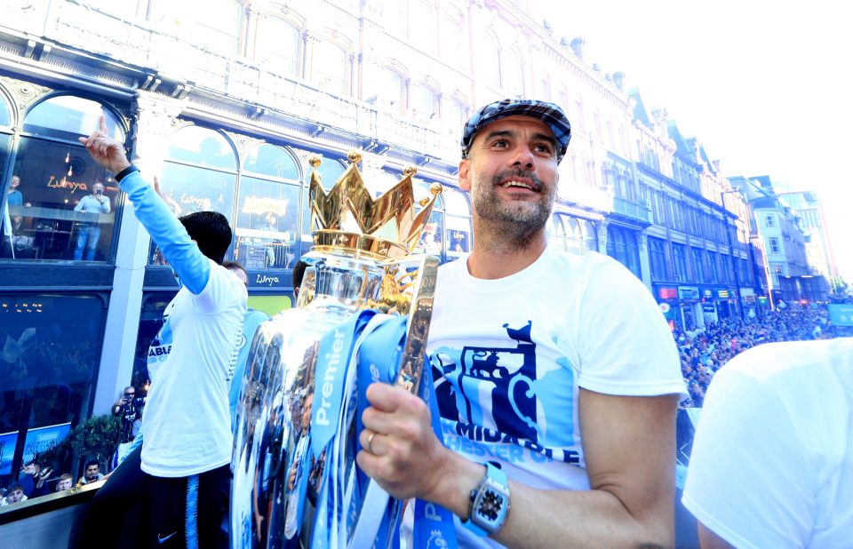  Pep Guardiola lifts the Premier League trophy during the bus parade