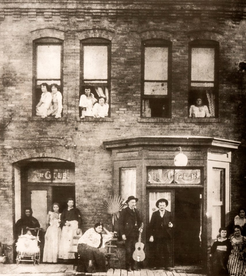  The Club in the gold rush town of Cripple Creek, Colorado, about 1892. The photo shows a quintessential Old West sin palace with musicians, the madam (bottom right, striped dress), housemaids and the ladies that wore white brothel gowns hanging out of the upstairs windows. There is also a baby in a pram, bottom left. Gold was struck in Cripple Creek in October, 1890. The town's population increased from a sparse 500 to a bustling 10,000 in just three years