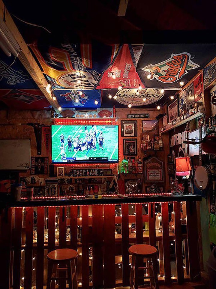  This bloke's home bar is a sports fan's heaven with memorabilia all over the ceiling and walls