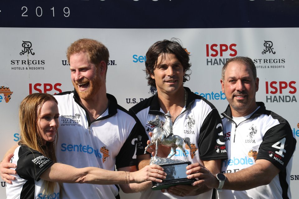  The Duke of Sussex grins as he poses with the trophy