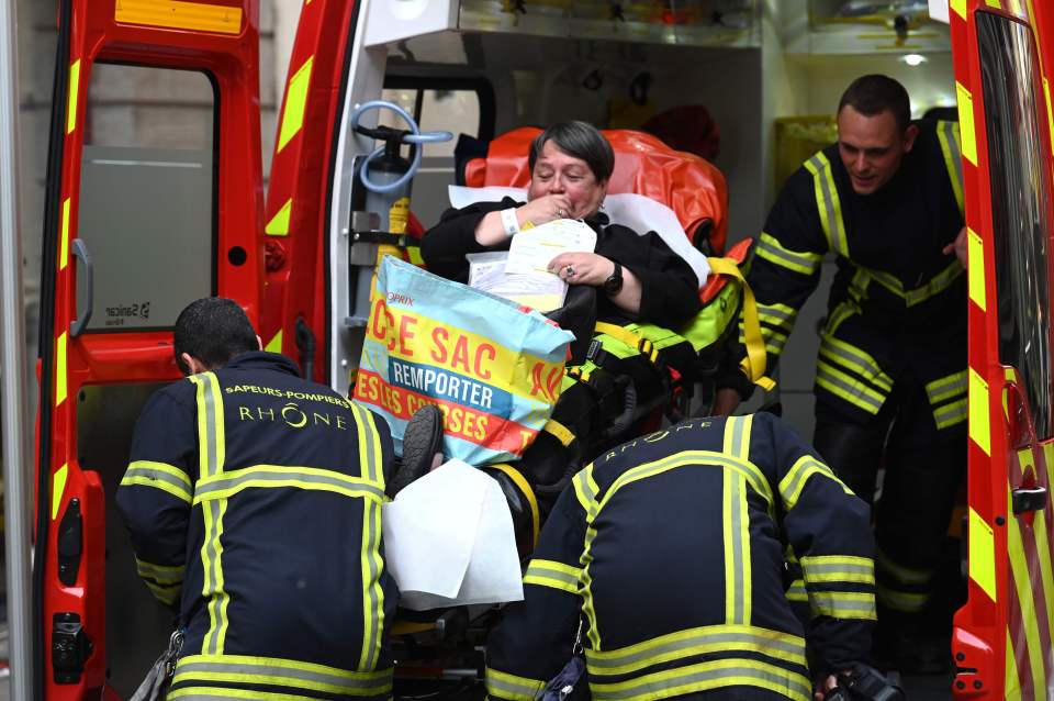  A woman is helped into an ambulance following the explosion which happened outside a bakery