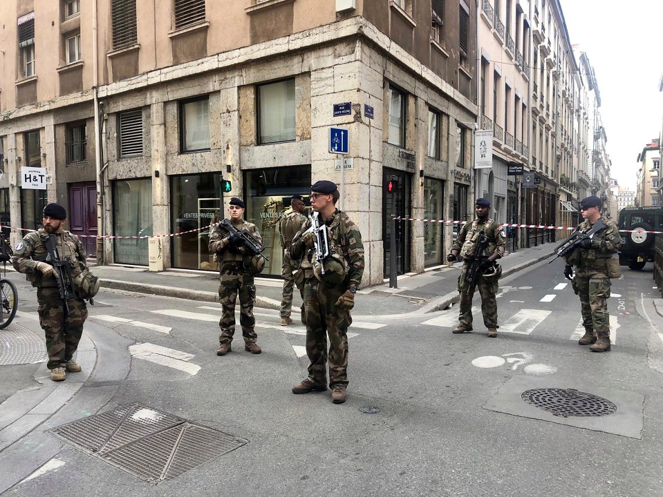  French soldiers holds rifles while standing guard in the Victor Hugo area of the city